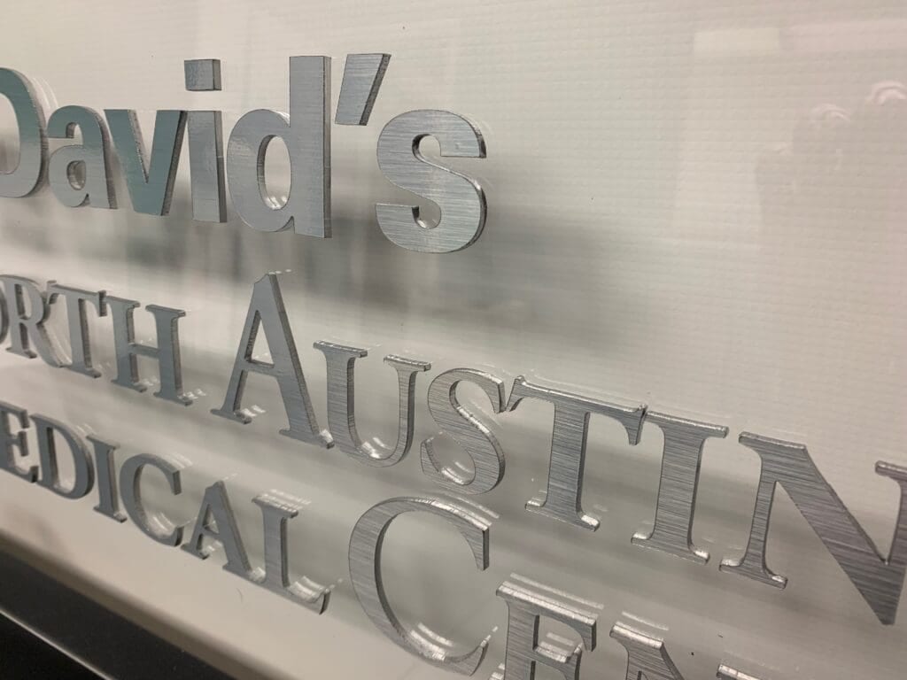 Acrylic with brushed metal face and silver painted sides